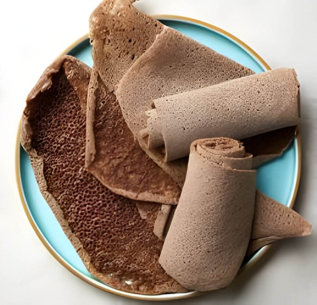 Close-up of injera bread on a blue plate