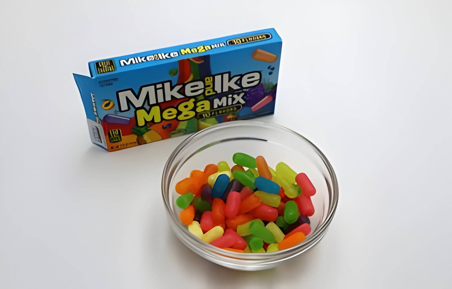 Bowl of colorful candy with a box of Mike and Ikes,